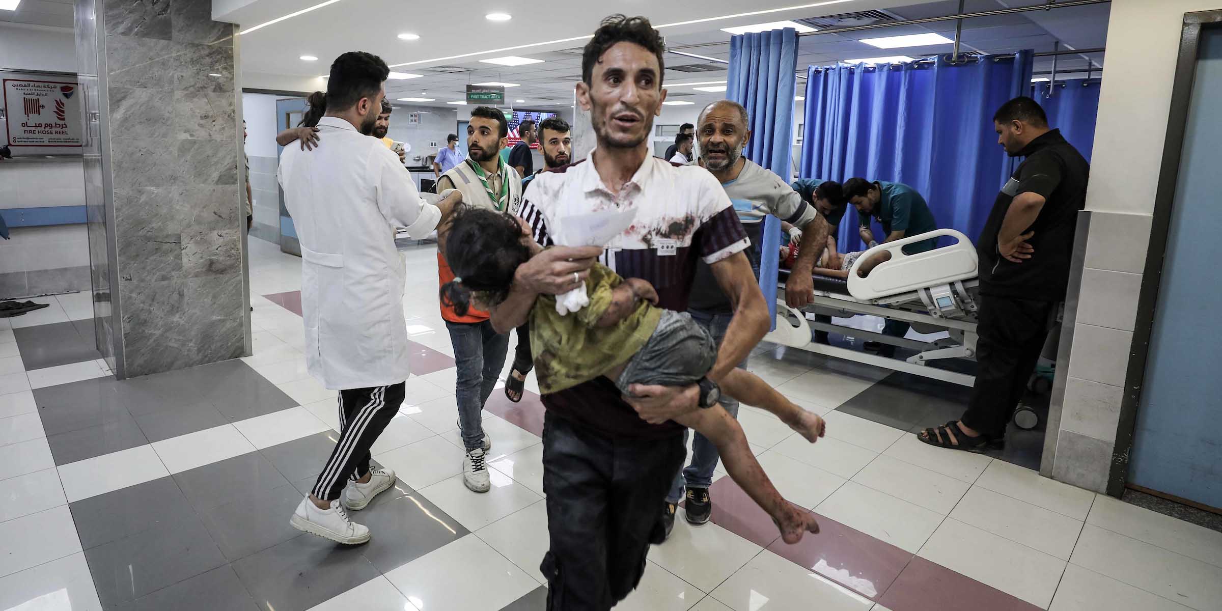 Wounded Palestinians wait for treatment at the overcrowded emergency ward of Al-Shifa hospital in Gaza